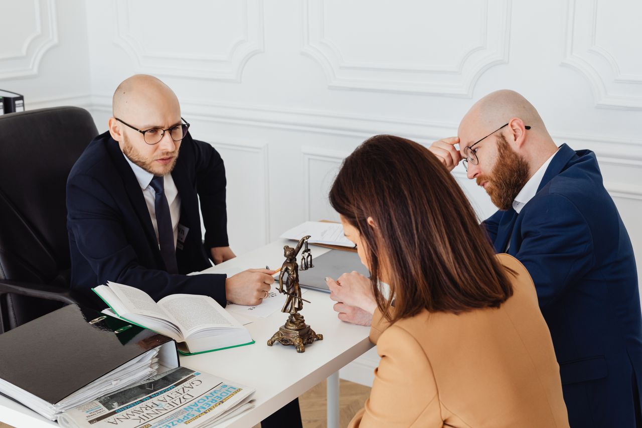about-01 Lawyer consulting clients in a modern office setting, serious discussion.